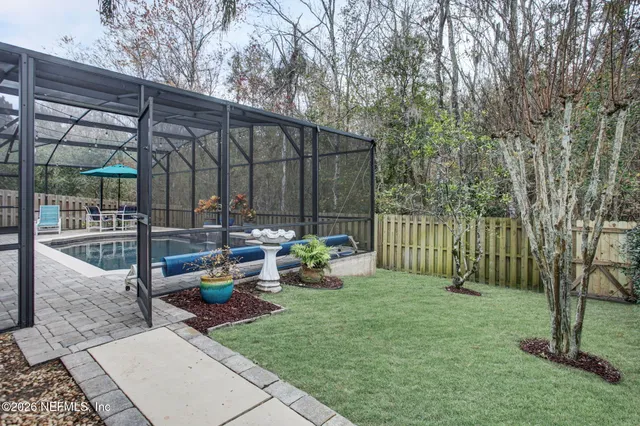 a view of backyard with outdoor seating and green space