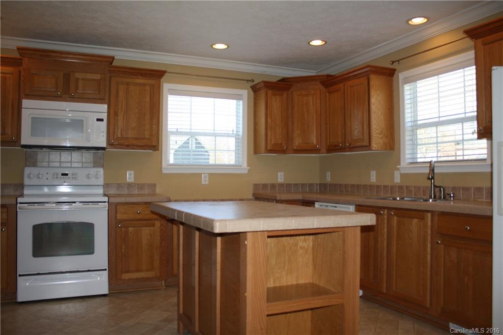 10866 Barberville Road Indian Land, SC 29707 - Photo 8 of 20 a kitchen with granite countertop a sink stove and cabinets