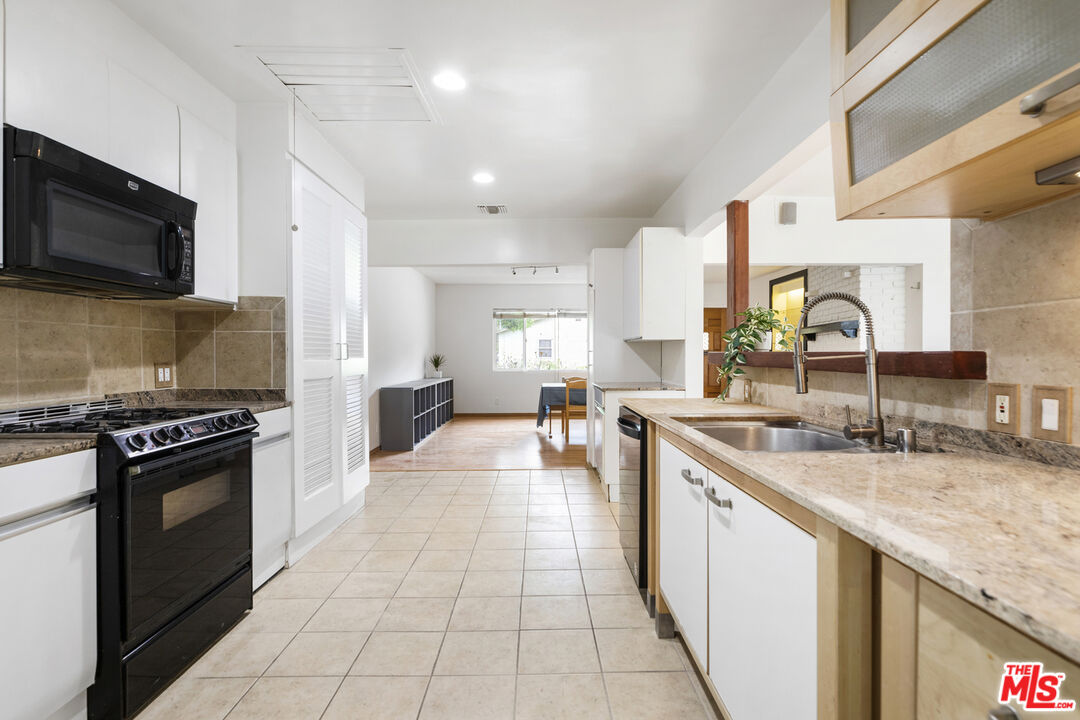 7716 Thousand Oaks Drive Tujunga, CA 91042 - Photo 13 of 34 a kitchen with stainless steel appliances granite countertop a sink and a stove