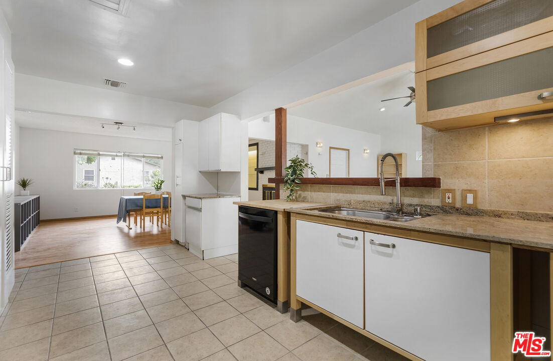 7716 Thousand Oaks Drive Tujunga, CA 91042 - Photo 15 of 34 a kitchen with a sink a counter top space cabinets and stainless steel appliances