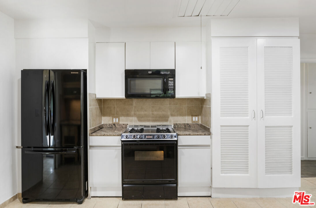 7716 Thousand Oaks Drive Tujunga, CA 91042 - Photo 16 of 34 a kitchen with cabinets and stainless steel appliances