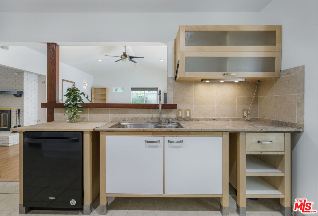 7716 Thousand Oaks Drive Tujunga, CA 91042 - Photo 17 of 34 a kitchen with a sink and a stove with wooden floor