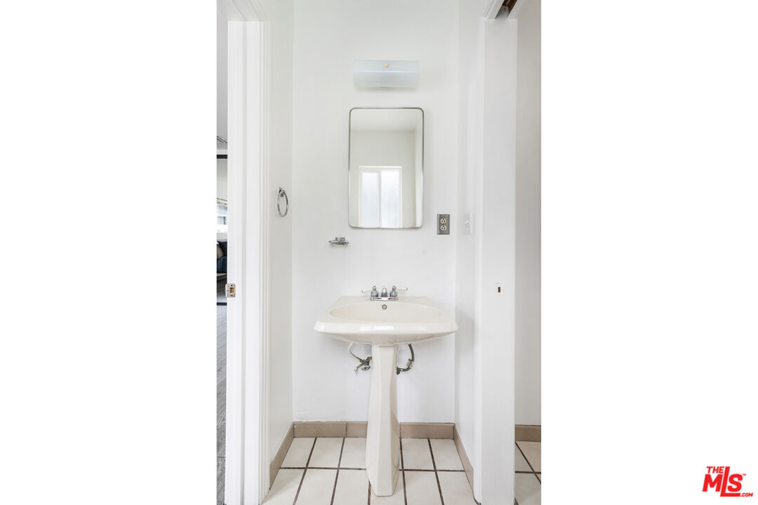7716 Thousand Oaks Drive Tujunga, CA 91042 - Photo 23 of 34 a bathroom with a sink a mirror and a vanity