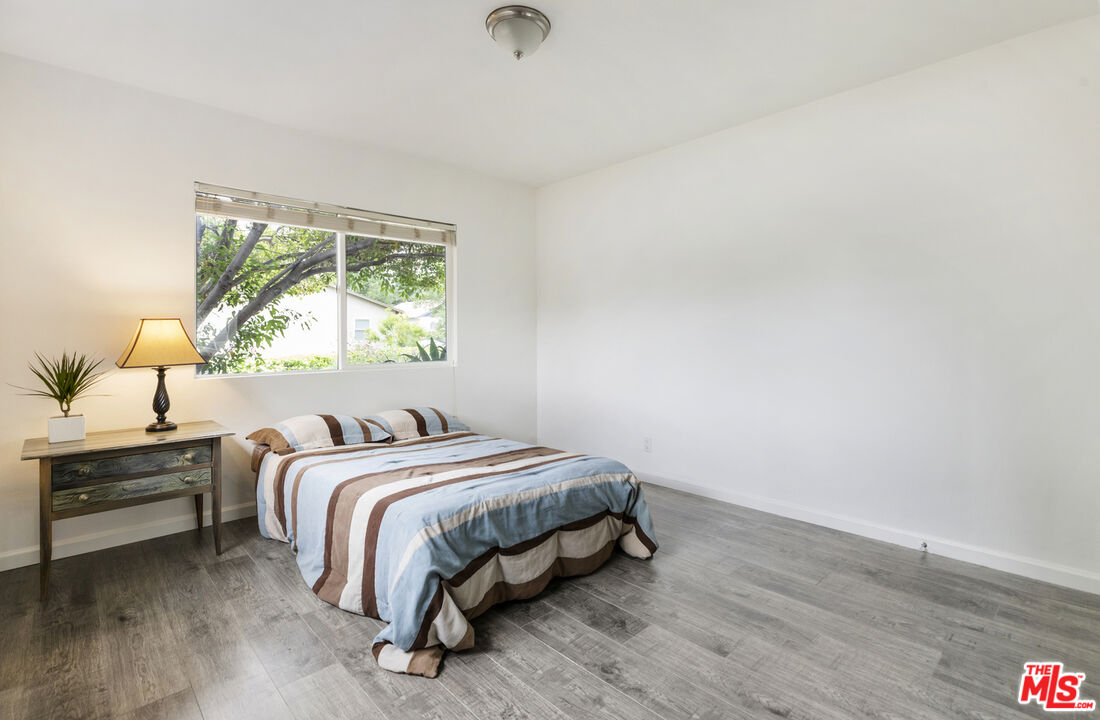7716 Thousand Oaks Drive Tujunga, CA 91042 - Photo 24 of 34 a bedroom with a bed and window
