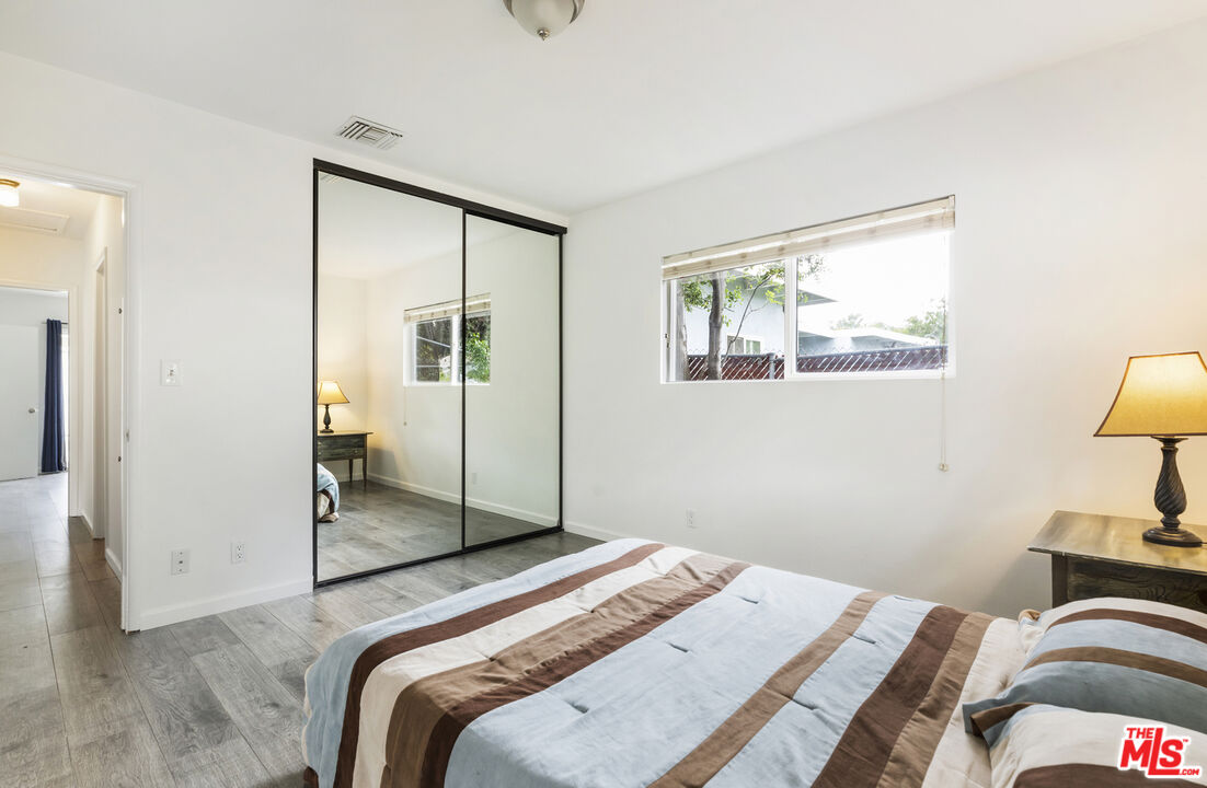 7716 Thousand Oaks Drive Tujunga, CA 91042 - Photo 25 of 34 a bedroom with a bed and a lamp on table