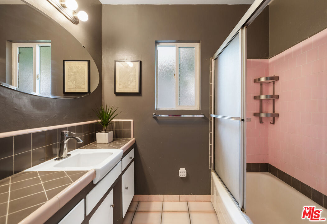 7716 Thousand Oaks Drive Tujunga, CA 91042 - Photo 26 of 34 a bathroom with a double vanity sink and a mirror