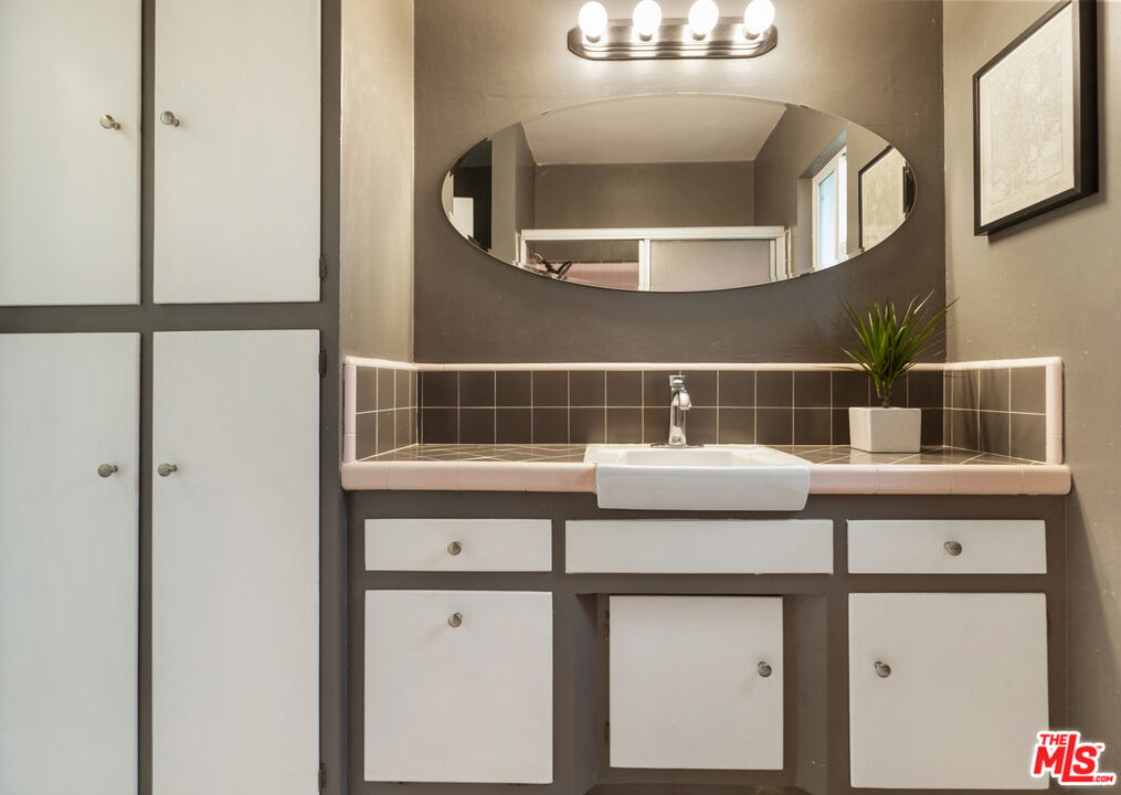 7716 Thousand Oaks Drive Tujunga, CA 91042 - Photo 27 of 34 a sink with a mirror