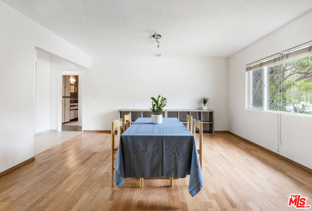 7716 Thousand Oaks Drive Tujunga, CA 91042 - Photo 7 of 34 a dining room with furniture and wooden floor