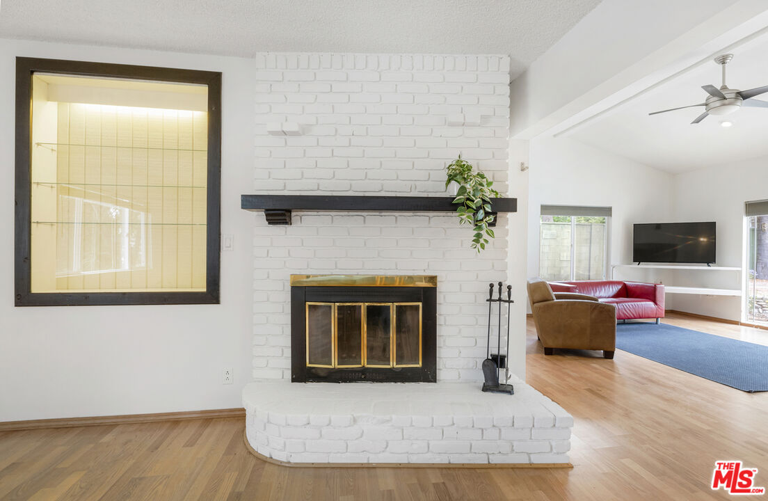 7716 Thousand Oaks Drive Tujunga, CA 91042 - Photo 8 of 34 a living room with furniture and a fireplace