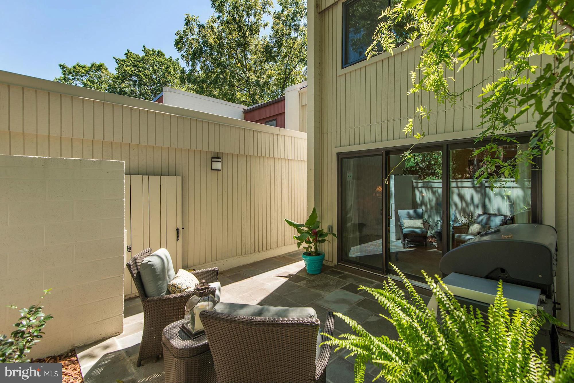 1620 Waters Edge Lane Reston, VA 20190 - Photo 2 of 30 a backyard of a house with table and chairs