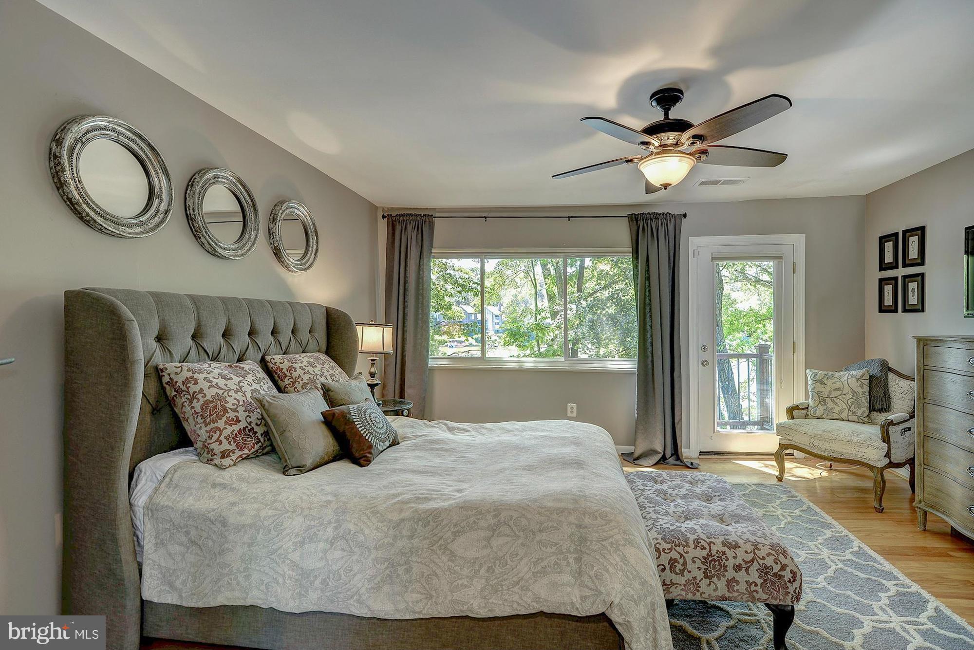 1620 Waters Edge Lane Reston, VA 20190 - Photo 17 of 30 a bedroom with a large bed and a chandelier