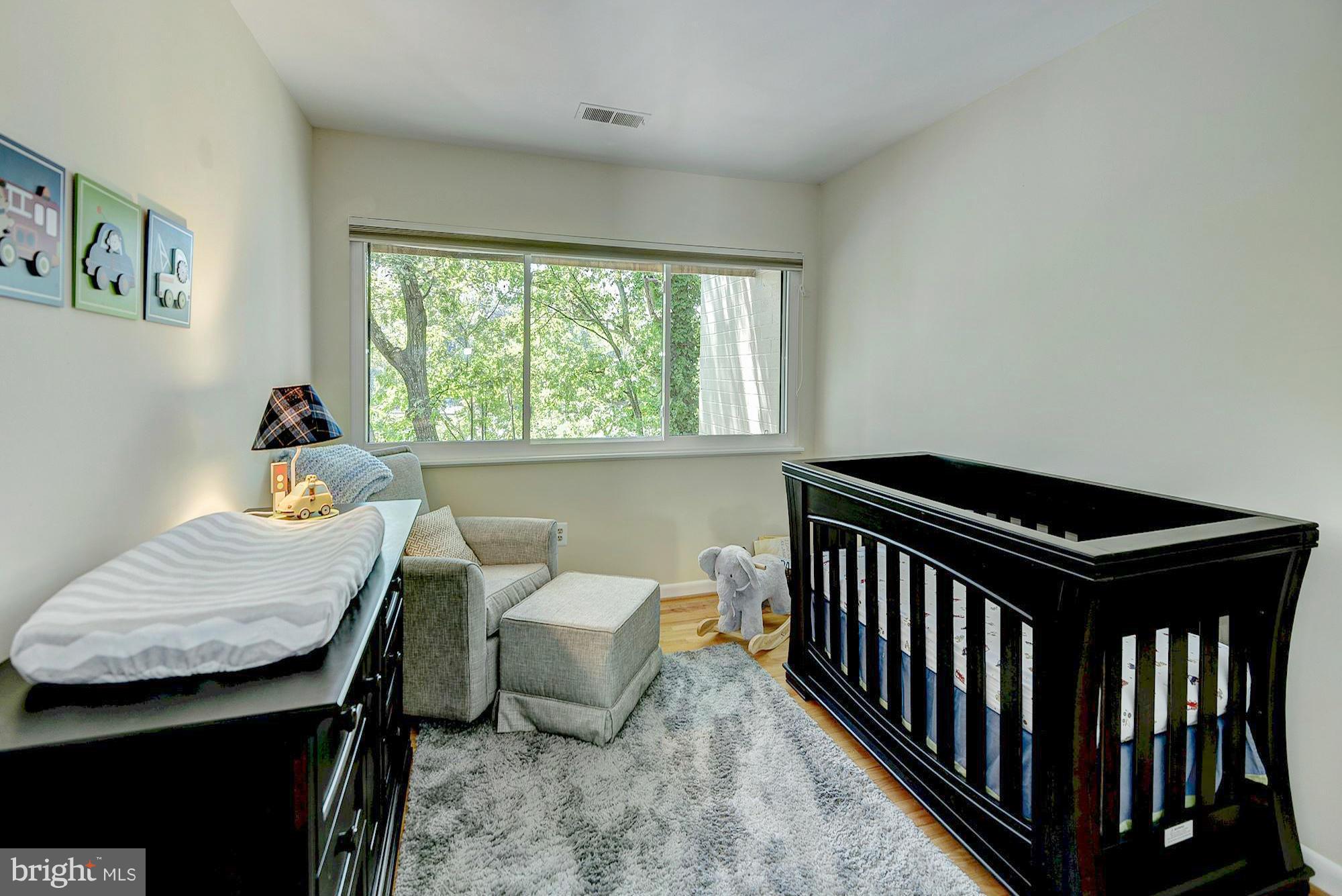 1620 Waters Edge Lane Reston, VA 20190 - Photo 23 of 30 a bedroom with a bed and a table in it