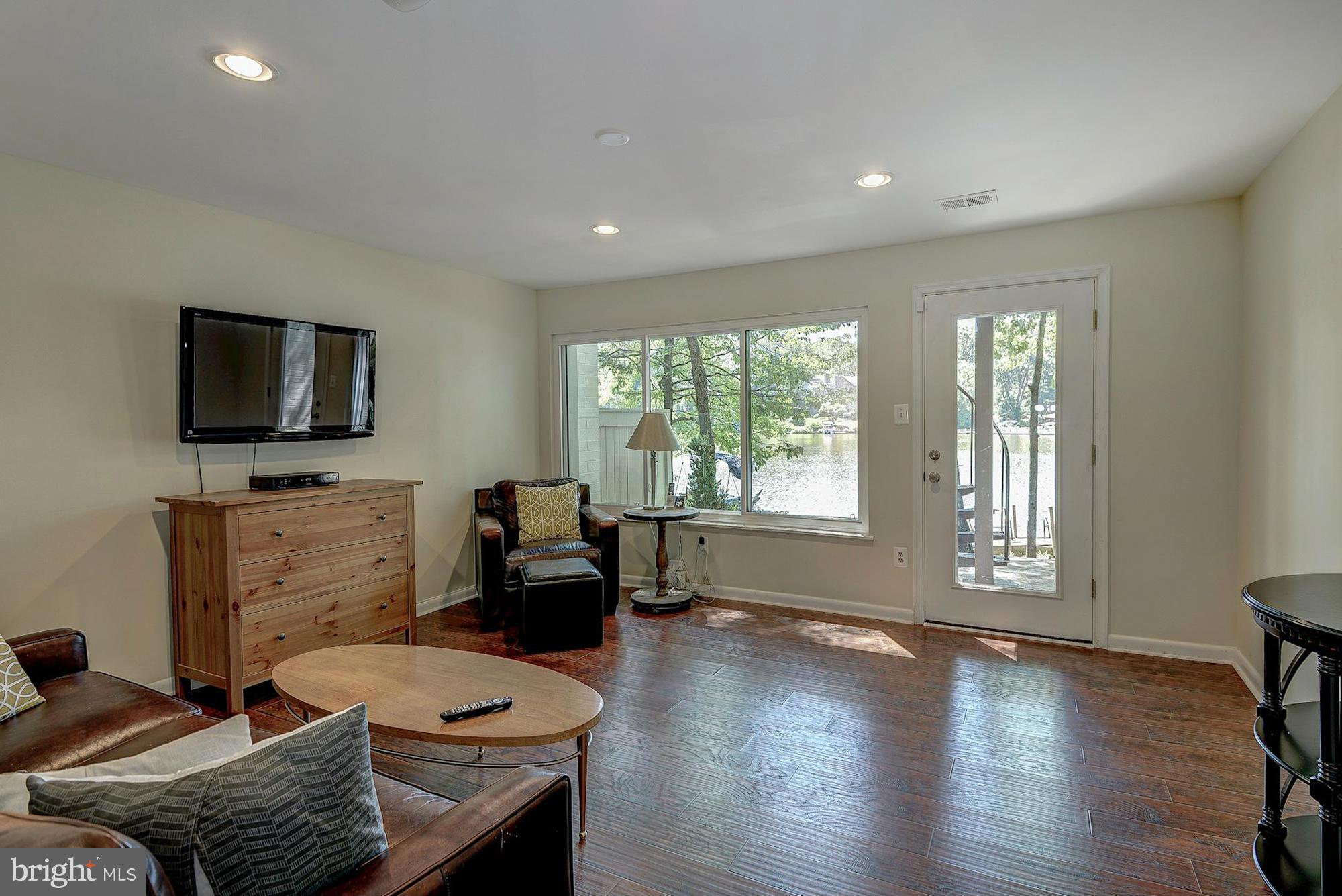 1620 Waters Edge Lane Reston, VA 20190 - Photo 26 of 30 a living room with furniture and a flat screen tv