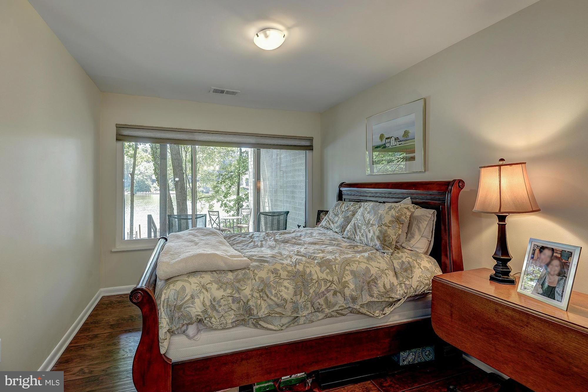 1620 Waters Edge Lane Reston, VA 20190 - Photo 27 of 30 a bedroom with a bed and wooden floor