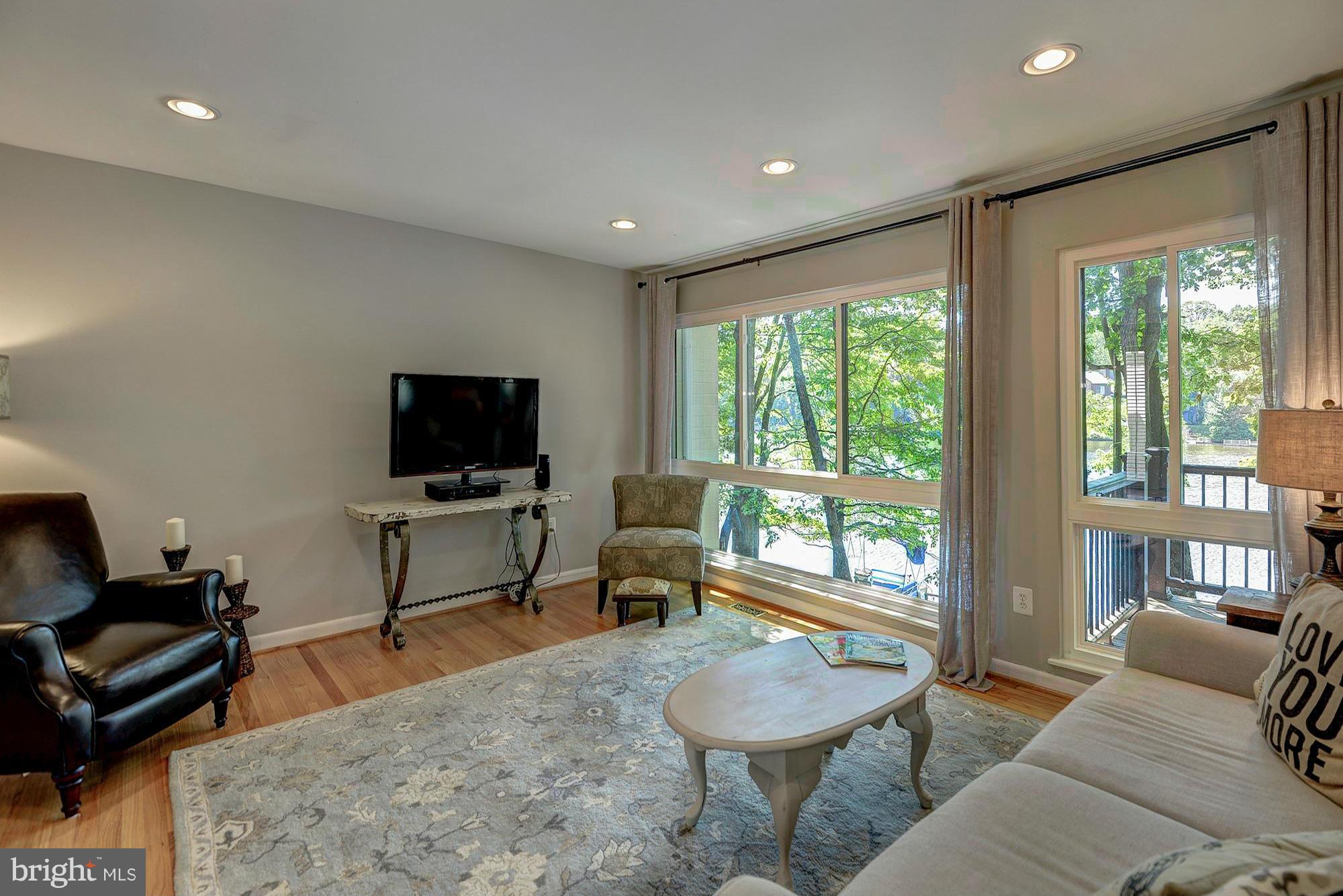 1620 Waters Edge Lane Reston, VA 20190 - Photo 5 of 30 a living room with furniture and a flat screen tv