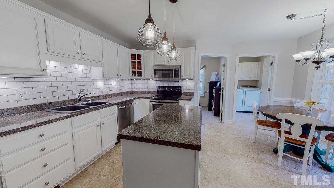 342 Punch Hill Farm Road Rougemont, NC 27572 - Photo 2 of 30 a kitchen with granite countertop kitchen island white cabinets and stainless steel appliances
