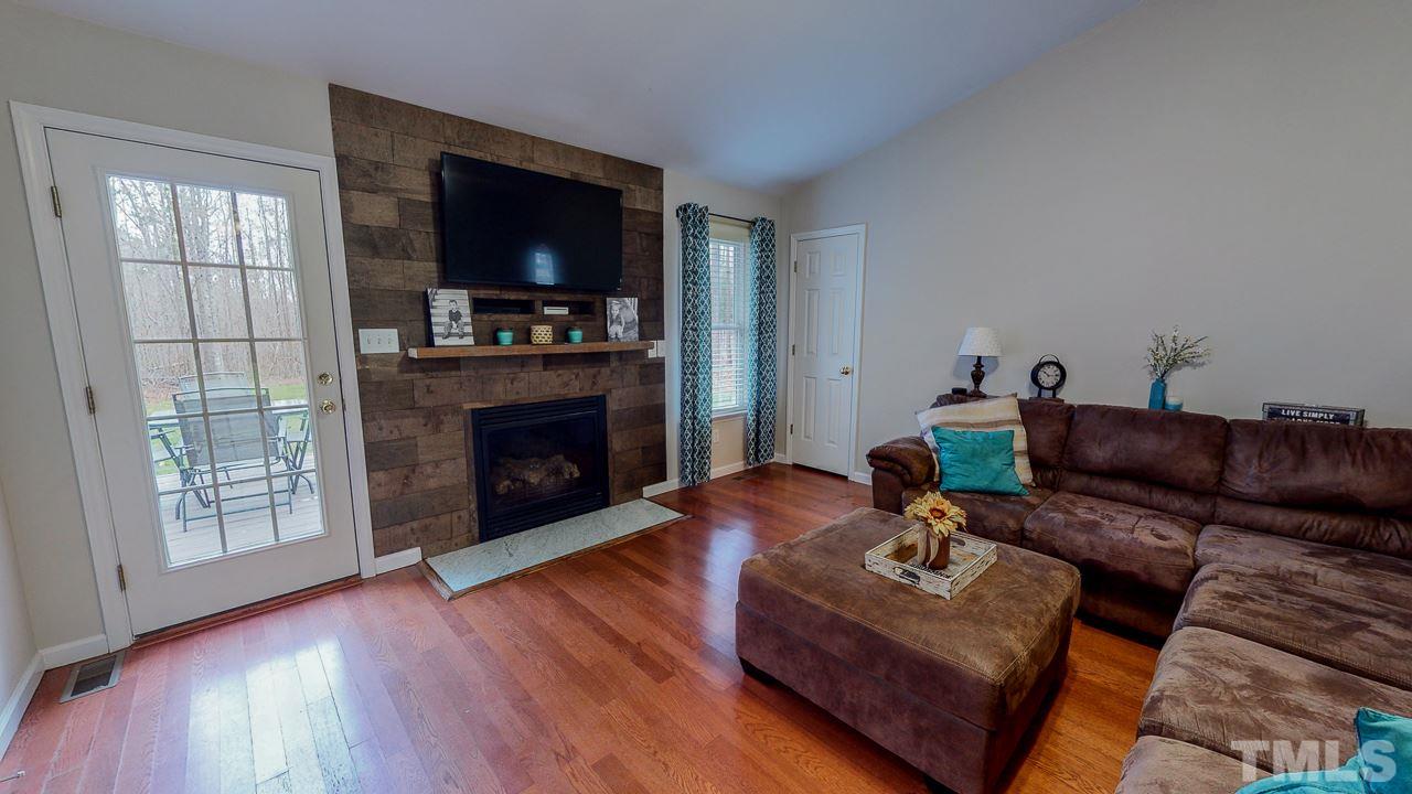 342 Punch Hill Farm Road Rougemont, NC 27572 - Photo 11 of 30 a living room with furniture a flat screen tv and a fireplace