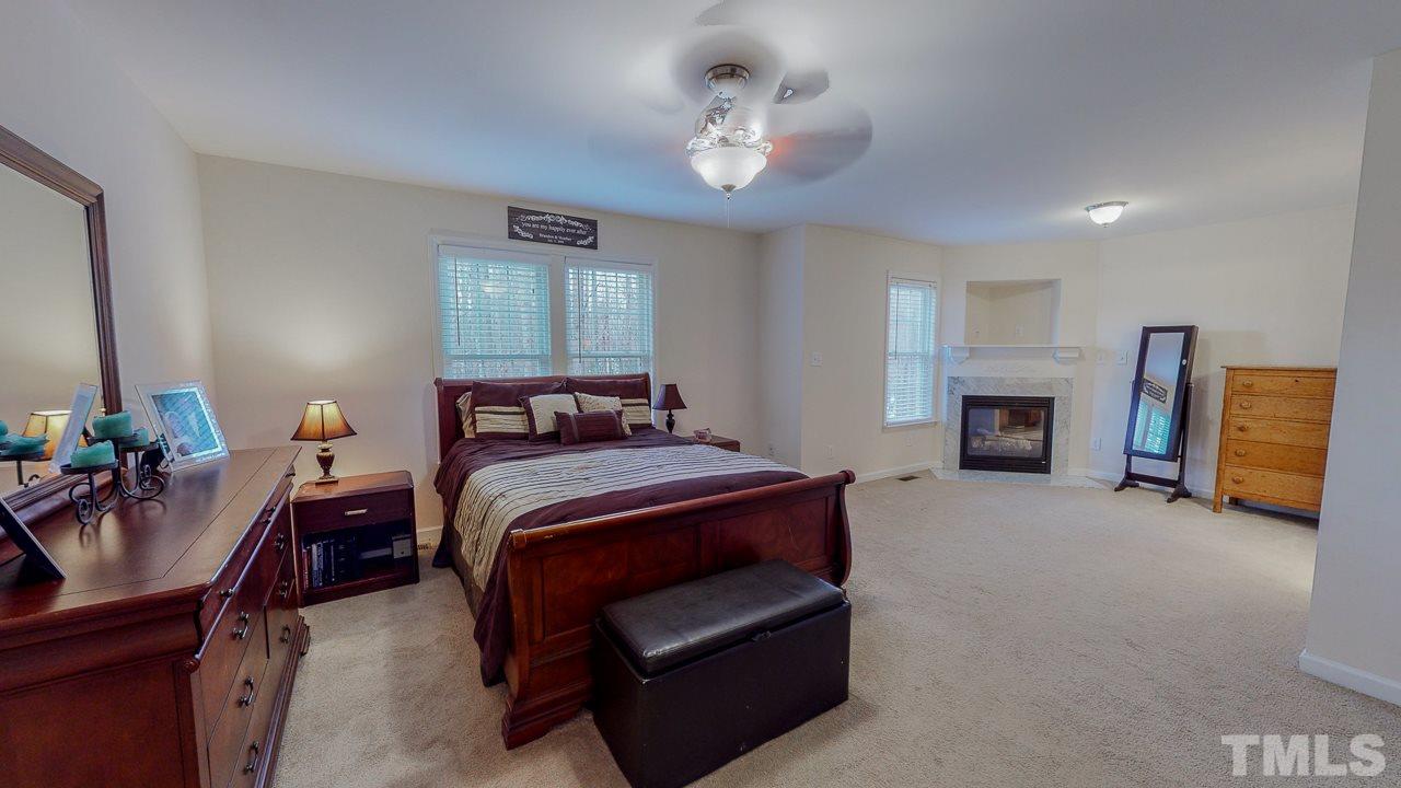342 Punch Hill Farm Road Rougemont, NC 27572 - Photo 12 of 30 a bedroom with a bed and a chandelier