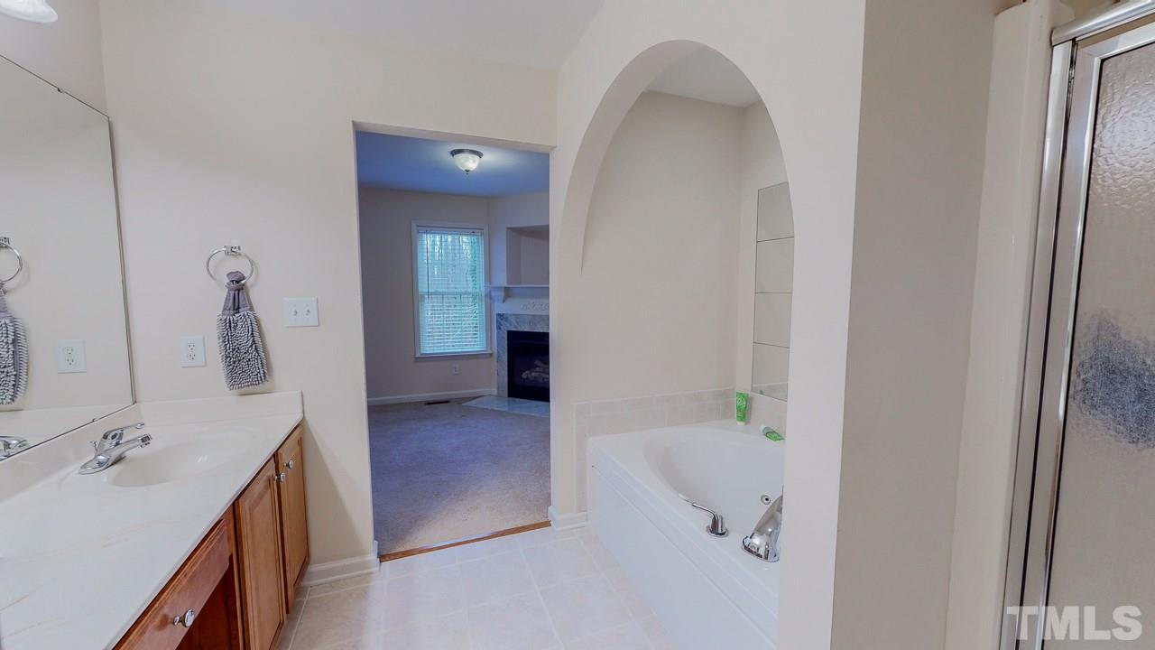 342 Punch Hill Farm Road Rougemont, NC 27572 - Photo 16 of 30 a bathroom with a tub sink and mirror