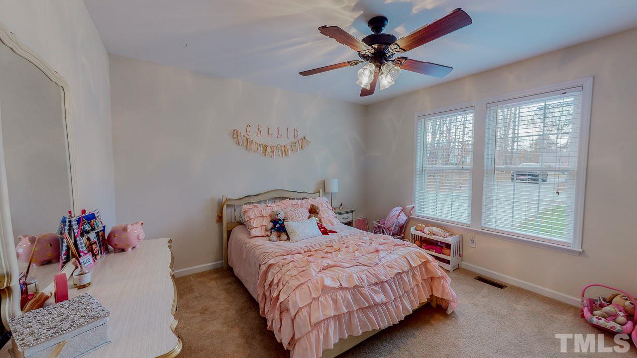 342 Punch Hill Farm Road Rougemont, NC 27572 - Photo 19 of 30 a bedroom with a bed and a chandelier fan