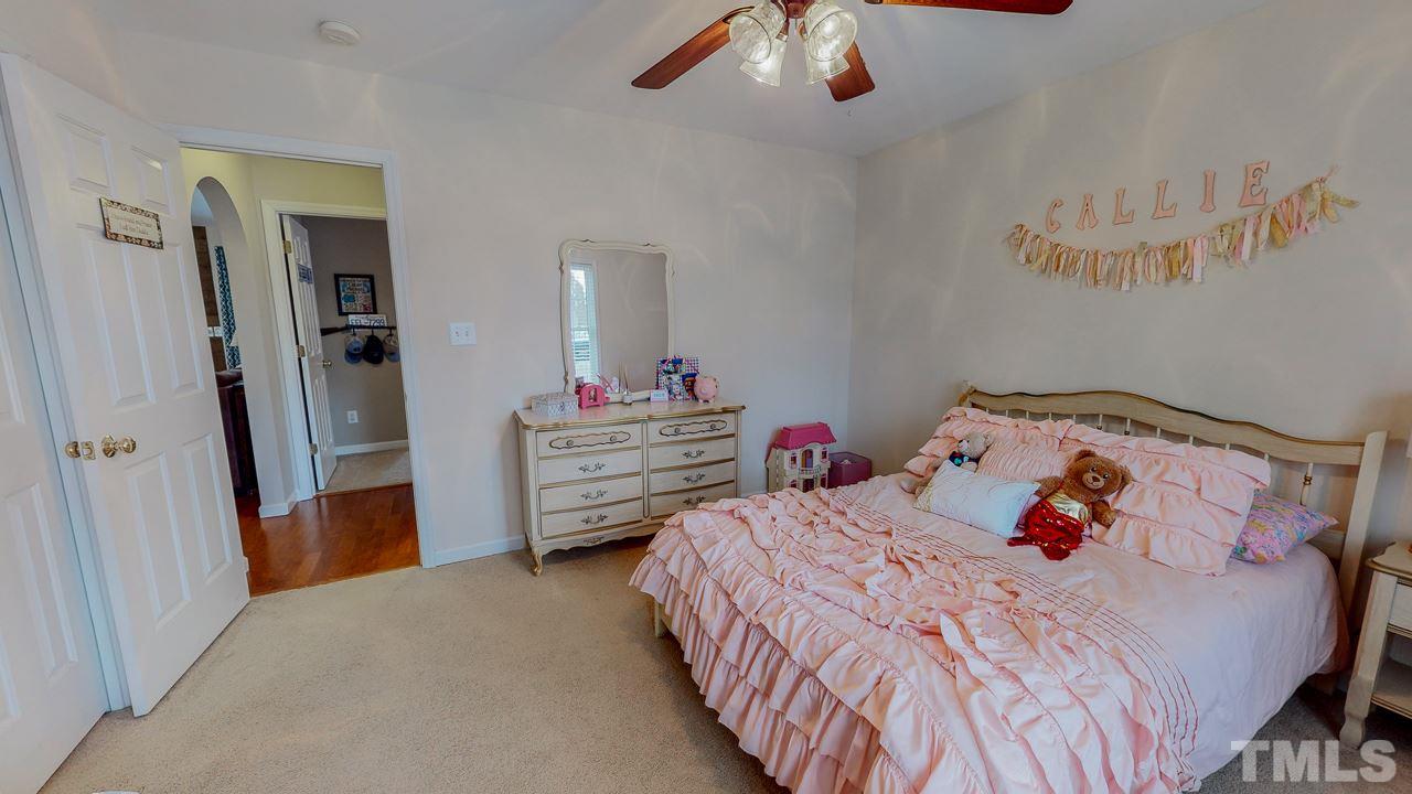 342 Punch Hill Farm Road Rougemont, NC 27572 - Photo 20 of 30 a bedroom with a bed and a chandelier