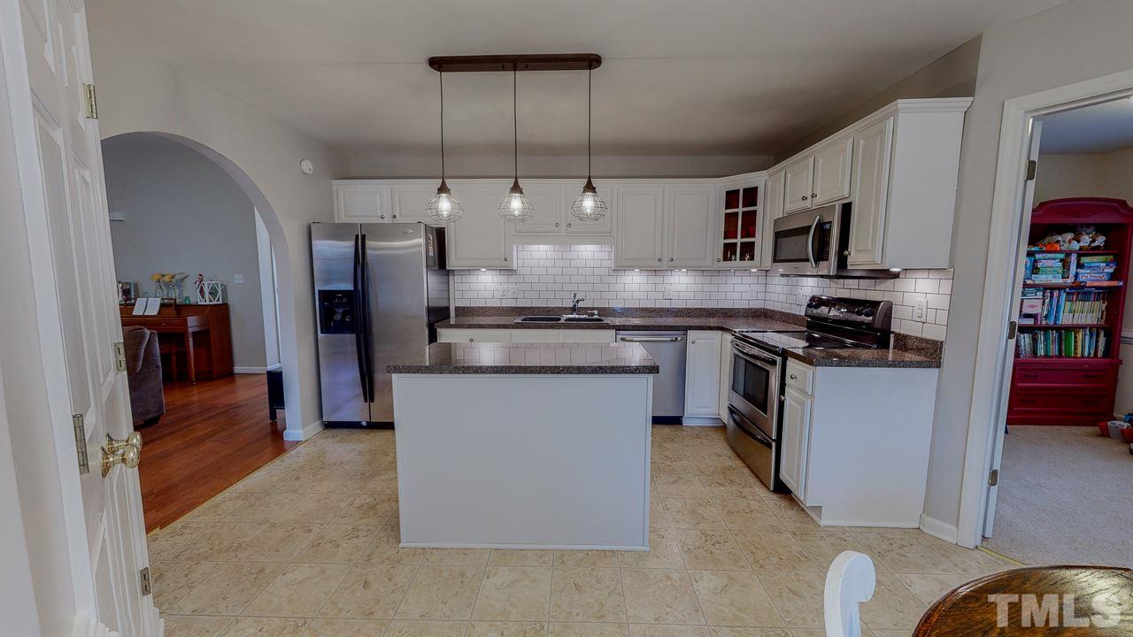 342 Punch Hill Farm Road Rougemont, NC 27572 - Photo 3 of 30 a kitchen with stainless steel appliances granite countertop a refrigerator a stove and a sink