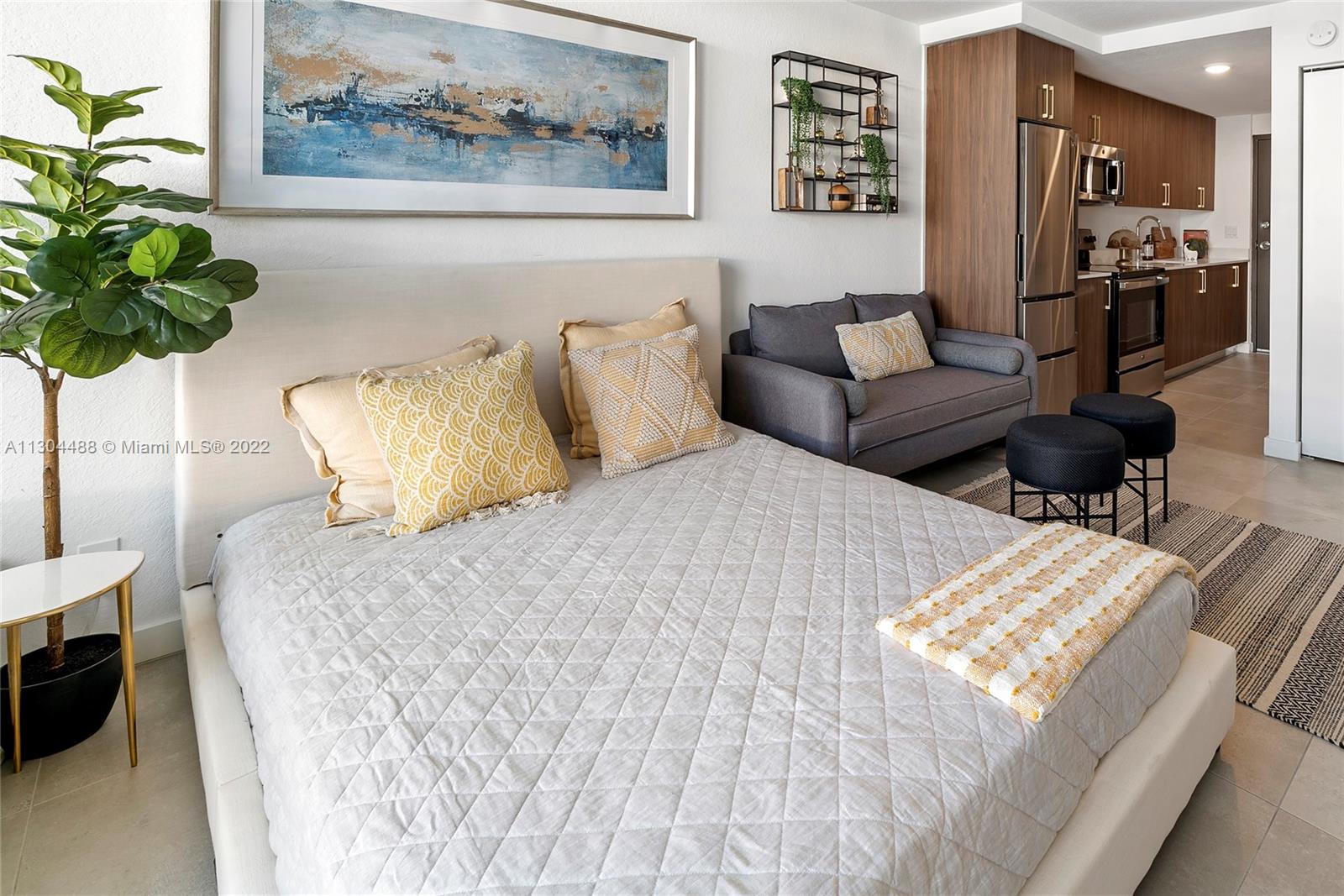 a bed sitting in a bedroom and painting on the wall