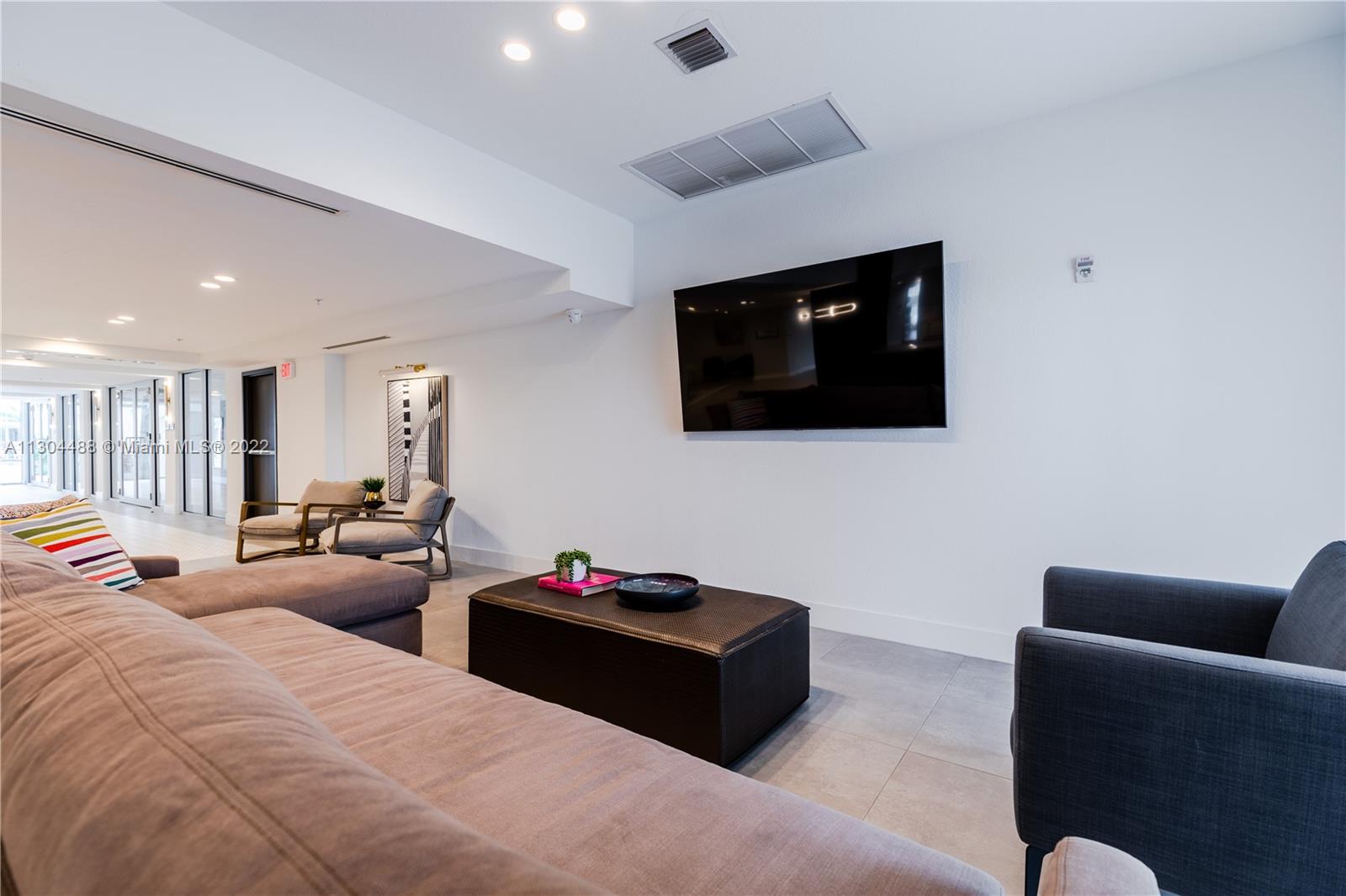 1950 West 49th Street, Unit 213 Hialeah, FL 33012 - Photo 24 of 49 a living room with furniture and a flat screen tv