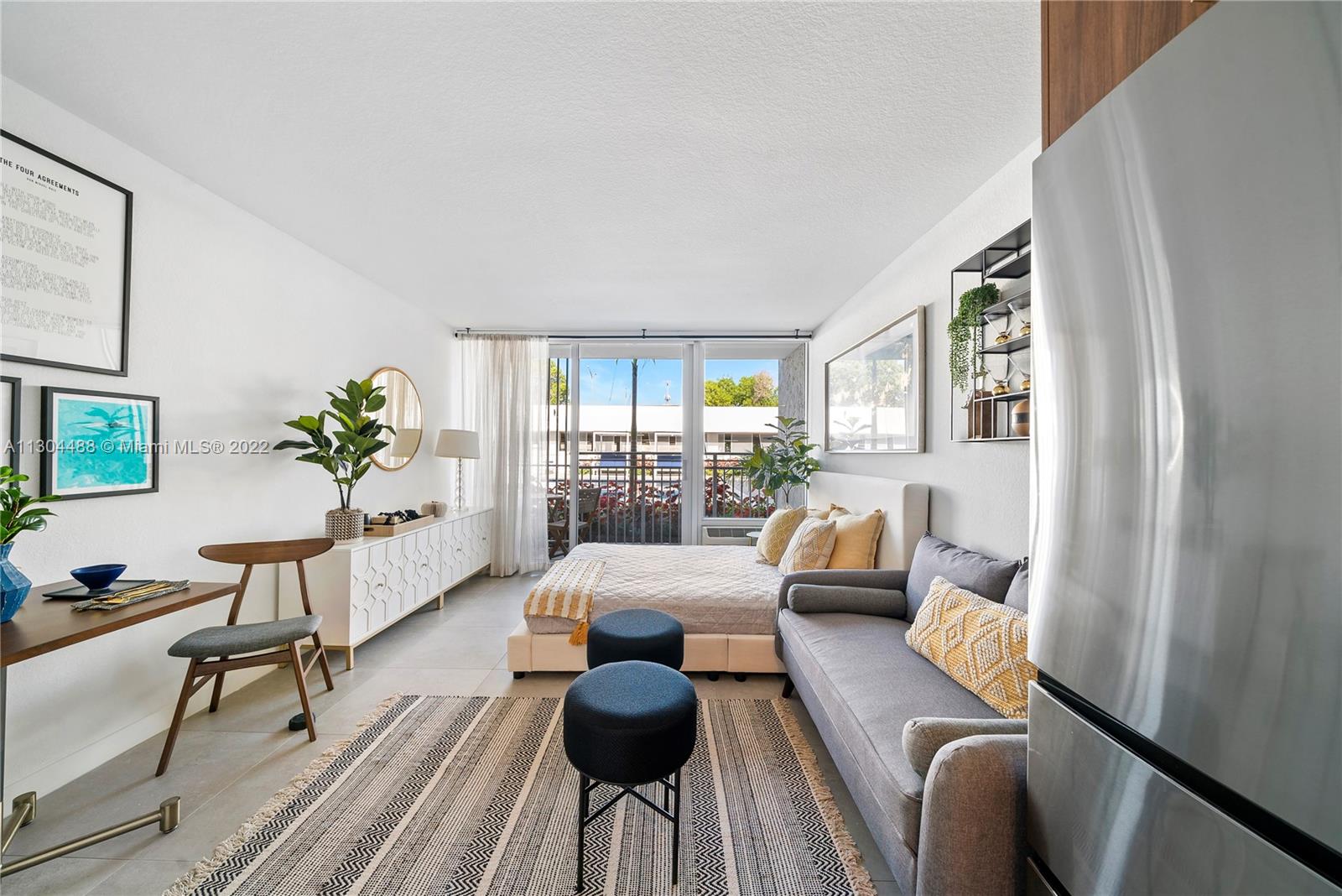 1950 West 49th Street, Unit 213 Hialeah, FL 33012 - Photo 4 of 49 a living room with furniture and wooden floor