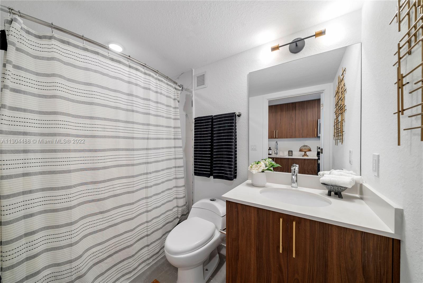 1950 West 49th Street, Unit 213 Hialeah, FL 33012 - Photo 6 of 49 a bathroom with a sink toilet vanity and toilet