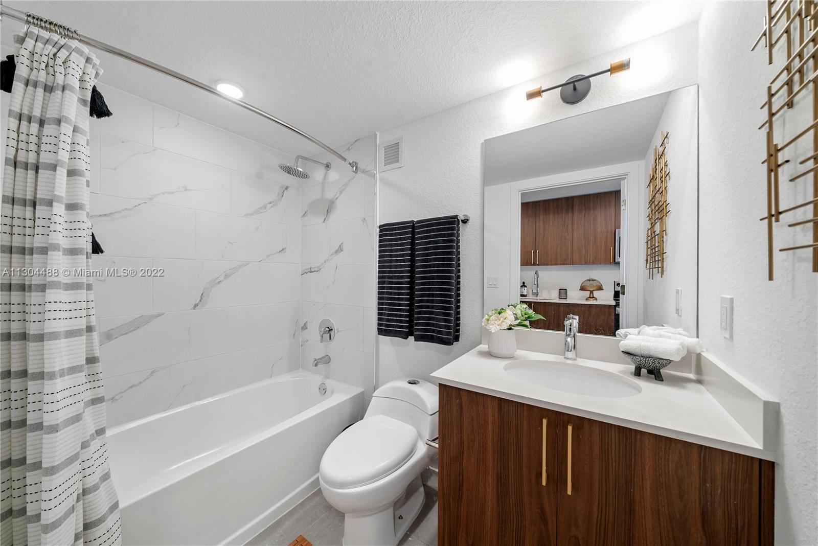1950 West 49th Street, Unit 213 Hialeah, FL 33012 - Photo 7 of 49 a bathroom with a double vanity sink toilet tub and shower