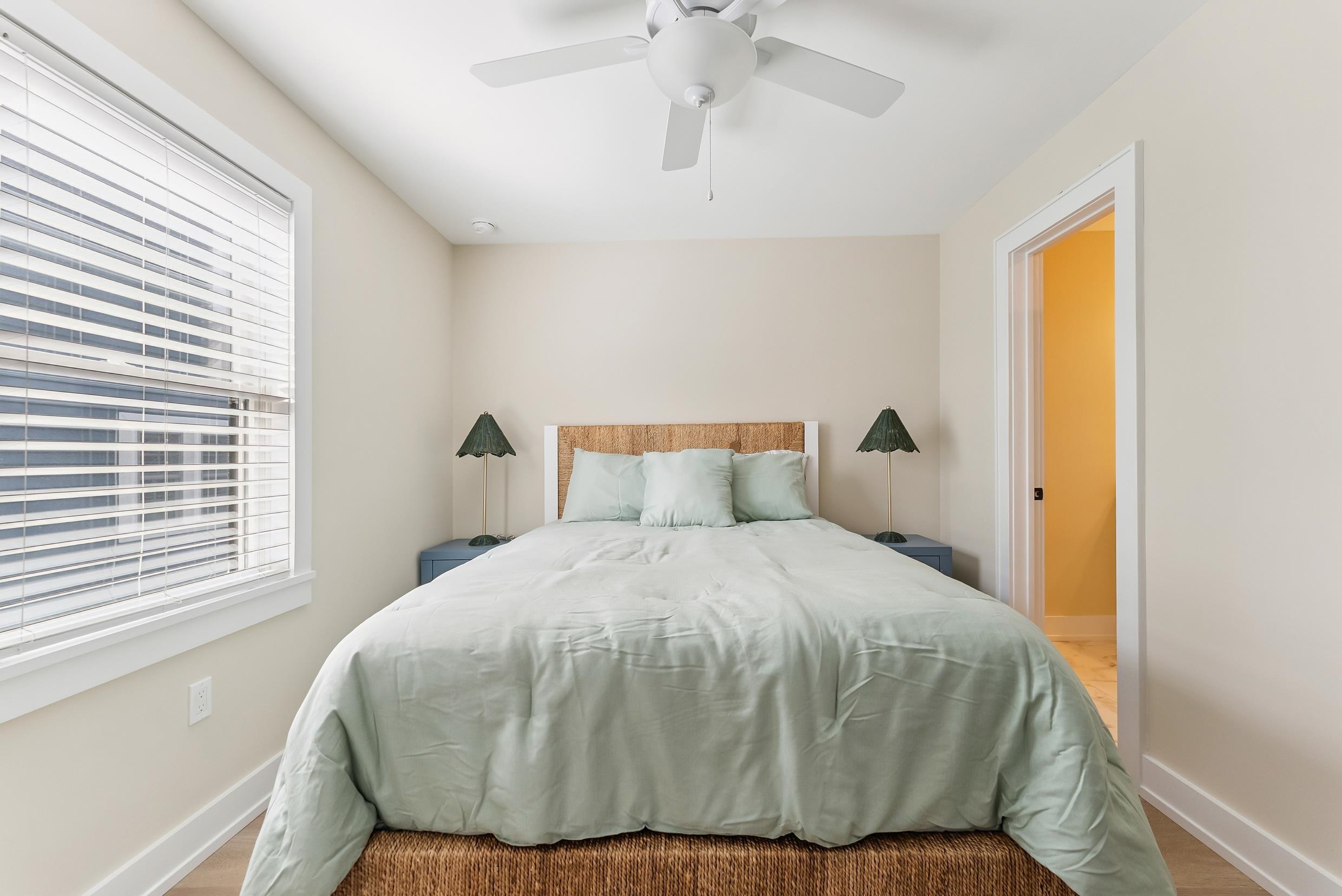 4301 Central, Unit NORTH Sea Isle City, NJ 08243 - Photo 33 of 47 a large bed sitting in a bedroom next to a window and a chandelier