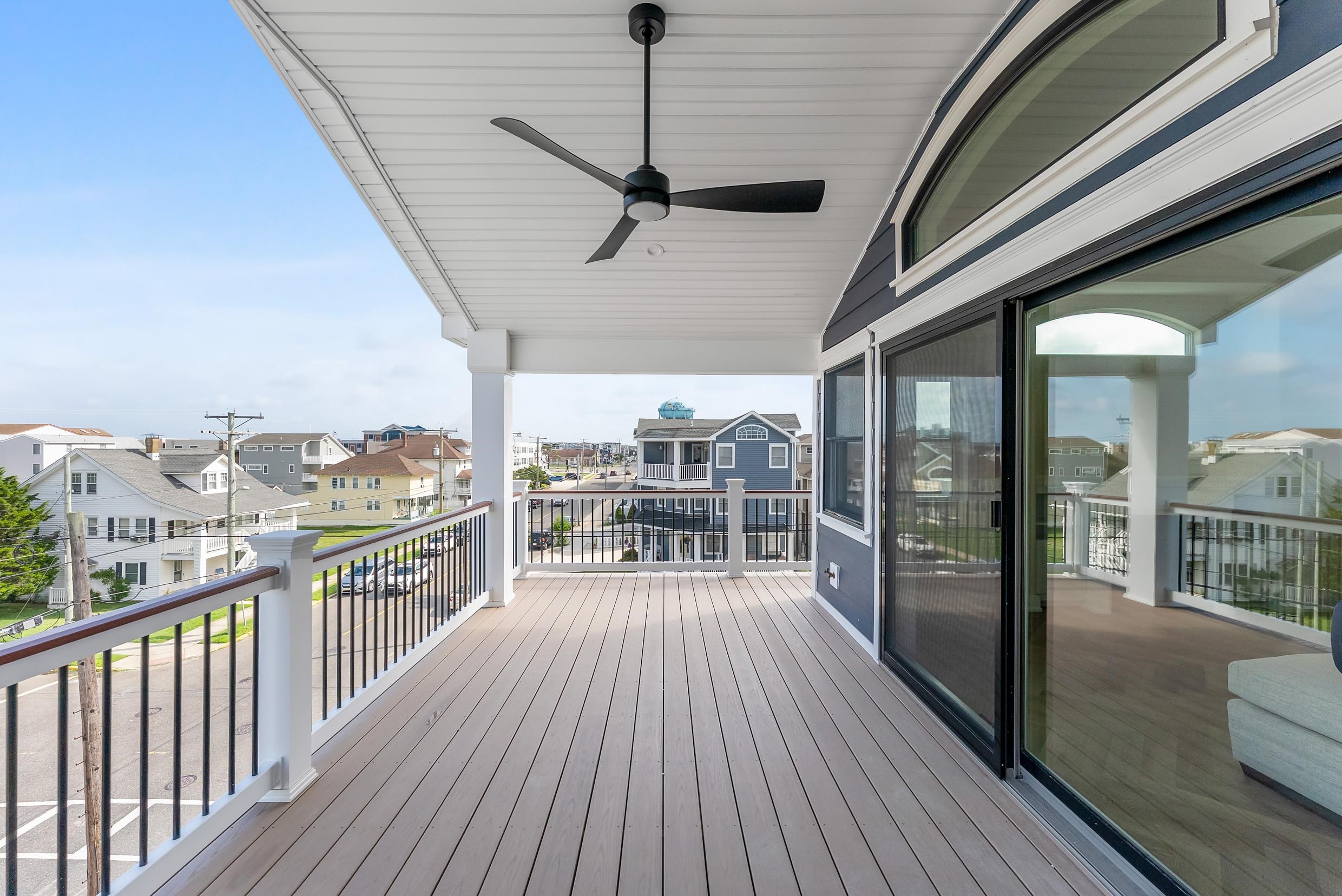 4301 Central, Unit NORTH Sea Isle City, NJ 08243 - Photo 43 of 47 a view of a balcony with floor to ceiling window wooden floor