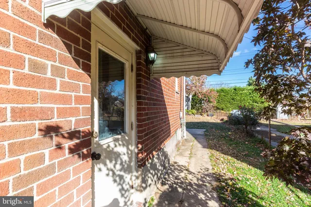a view of a pathway of a house with a yard