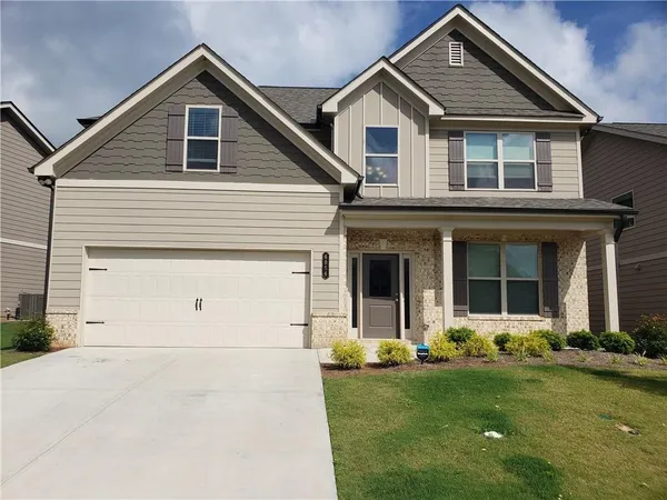 a front view of a house with a yard
