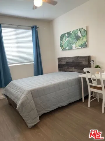 a bedroom with a bed and a table in it