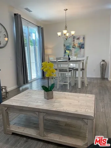 a view of dining table with granite countertop wooden floor