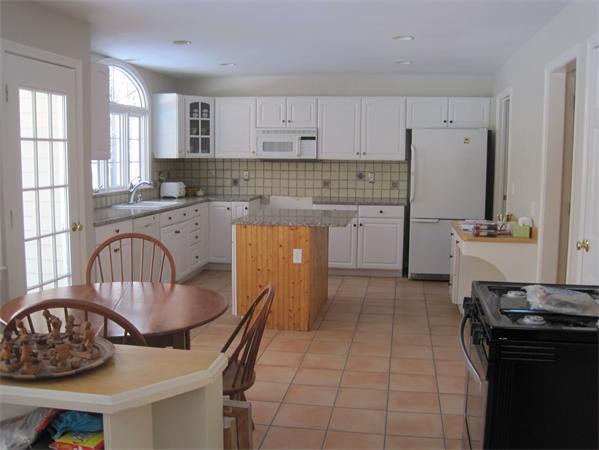 728 Burroughs Road Boxborough, MA 01719 - Photo 8 of 21 a kitchen with a stove a sink and a refrigerator