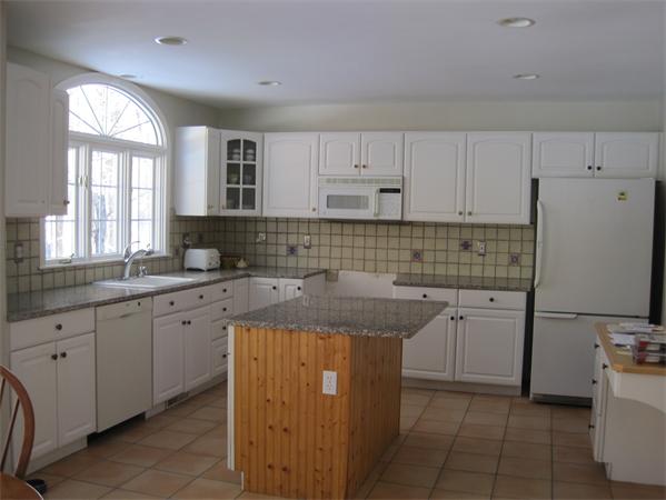 728 Burroughs Road Boxborough, MA 01719 - Photo 9 of 21 a kitchen with cabinets appliances a sink and a window