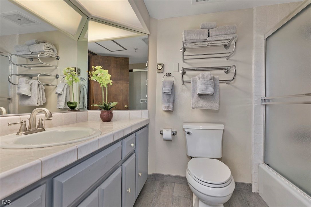 333 Ski Way, Unit 277 Incline Village, NV 89451 - Photo 19 of 33 a bathroom with a granite countertop toilet sink and mirror