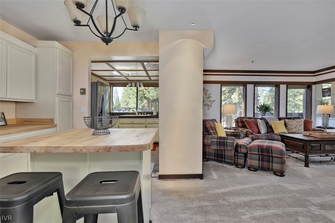 333 Ski Way, Unit 277 Incline Village, NV 89451 - Photo 8 of 33 a living room with furniture a window and a chandelier