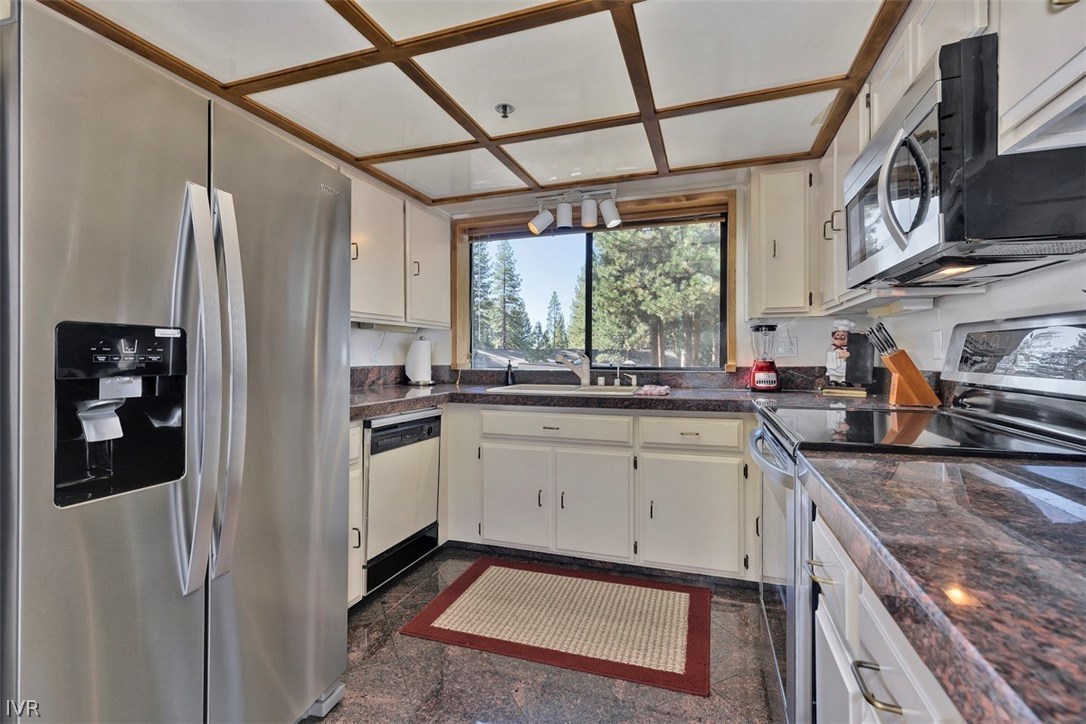 333 Ski Way, Unit 277 Incline Village, NV 89451 - Photo 9 of 33 a kitchen with stainless steel appliances granite countertop a refrigerator and a sink