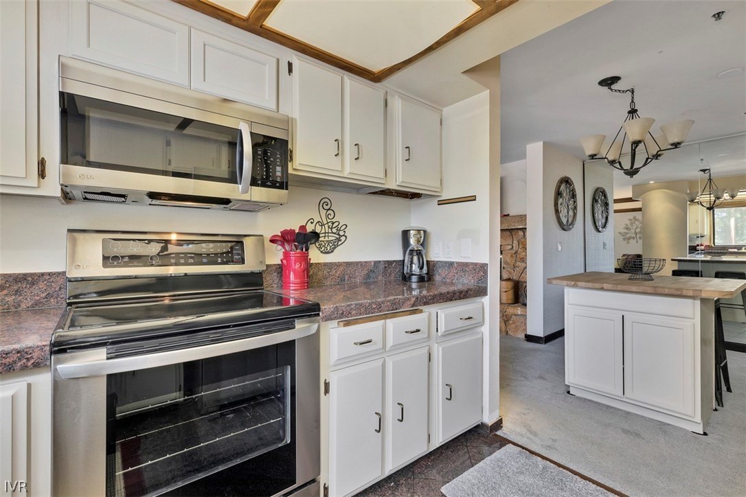 333 Ski Way, Unit 277 Incline Village, NV 89451 - Photo 10 of 33 a kitchen with white cabinets and stainless steel appliances