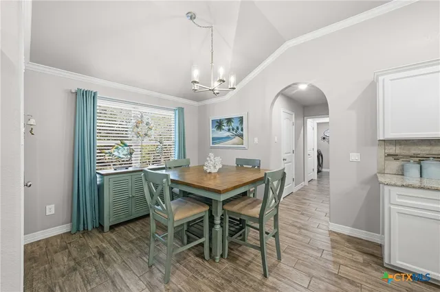 a living room with furniture flat screen tv and wooden floor