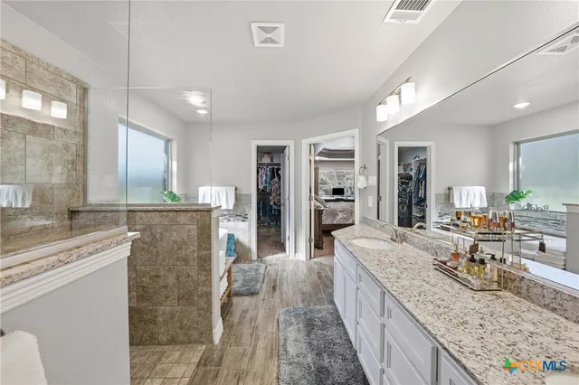 a bathroom with a granite countertop sink mirror and double