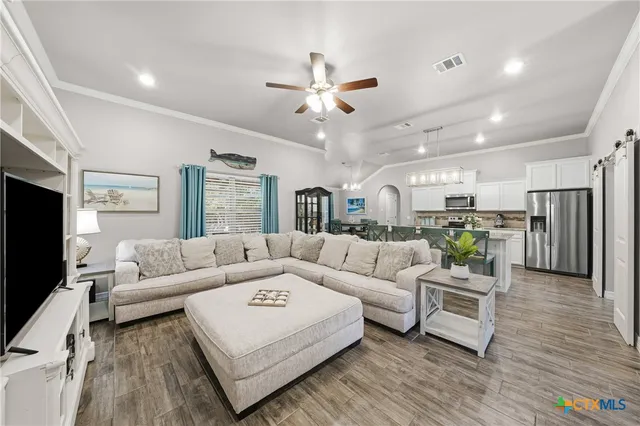 a living room with furniture and a flat screen tv