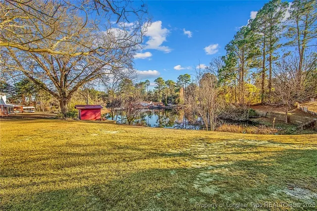 a swimming pool with outdoor seating and yard