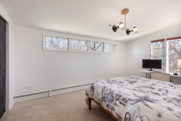 51 Wilcox Avenue Elgin, IL 60123 - Photo 12 of 20 a bedroom with a bed and a flat screen tv