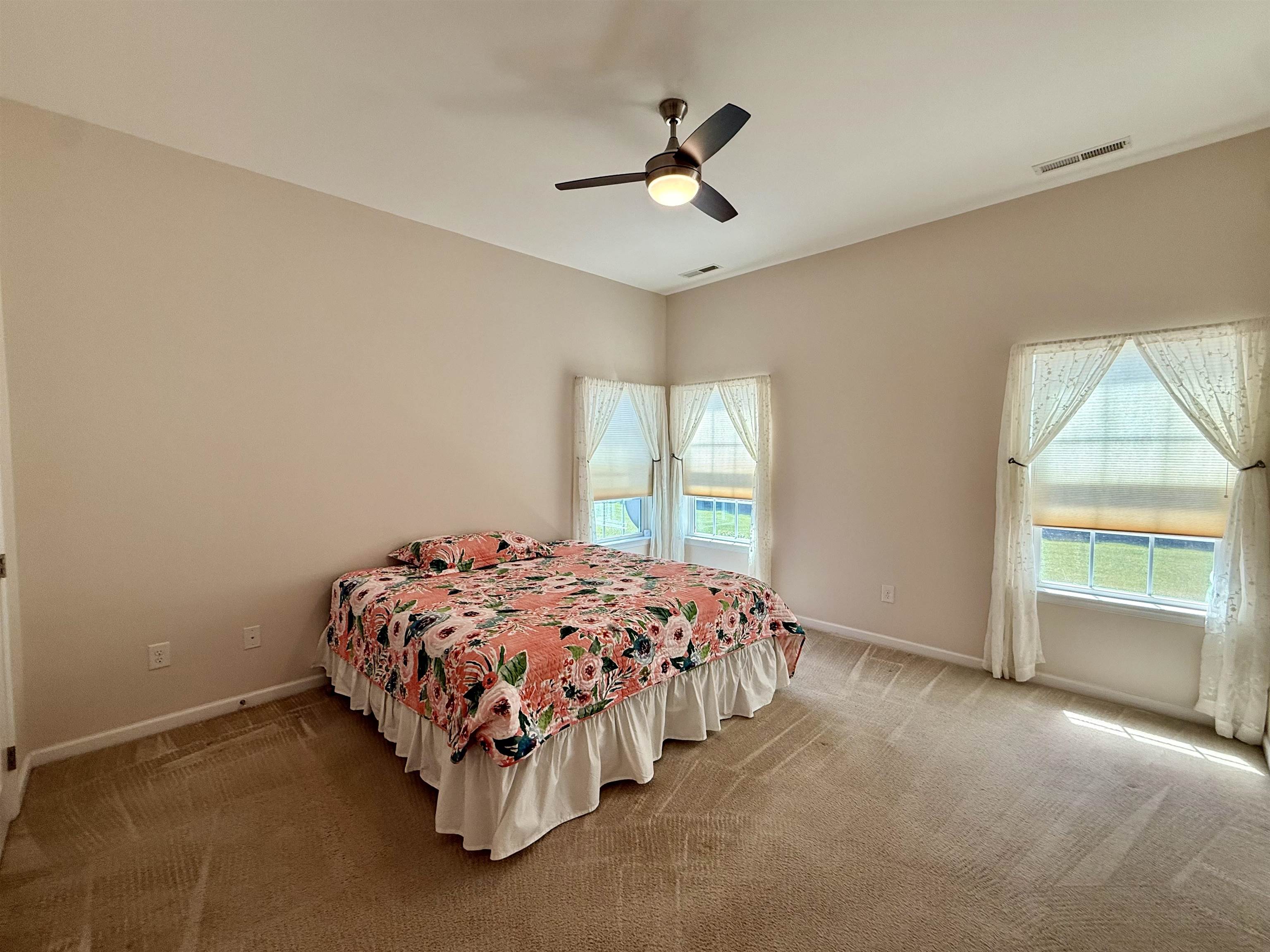 1607 Tidewater Avenue, Unit 1607 Rio Grande, NJ 08242 - Photo 17 of 42 a bedroom with a bed and a ceiling fan