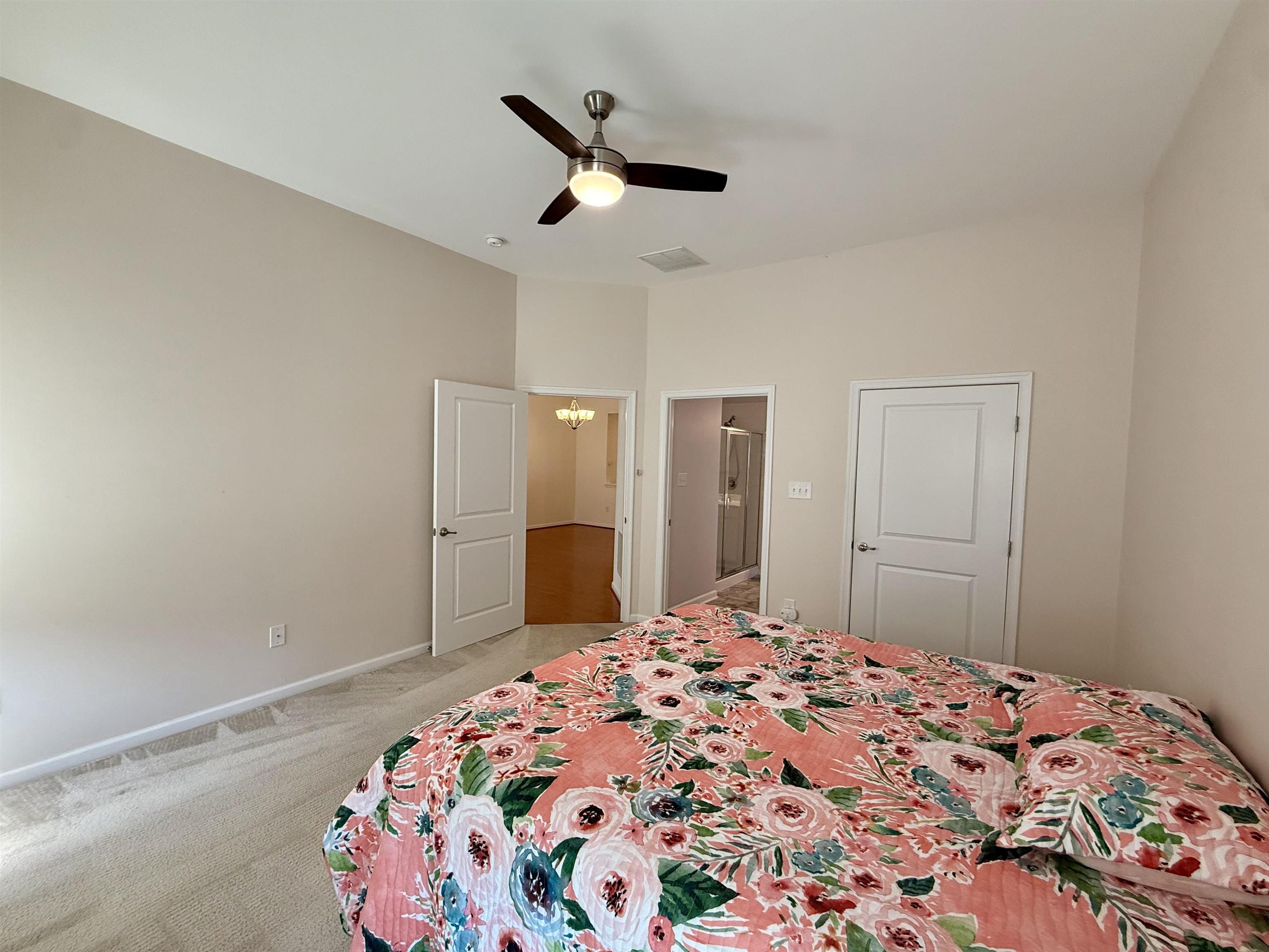 1607 Tidewater Avenue, Unit 1607 Rio Grande, NJ 08242 - Photo 18 of 42 a bedroom with a bed and a chandelier